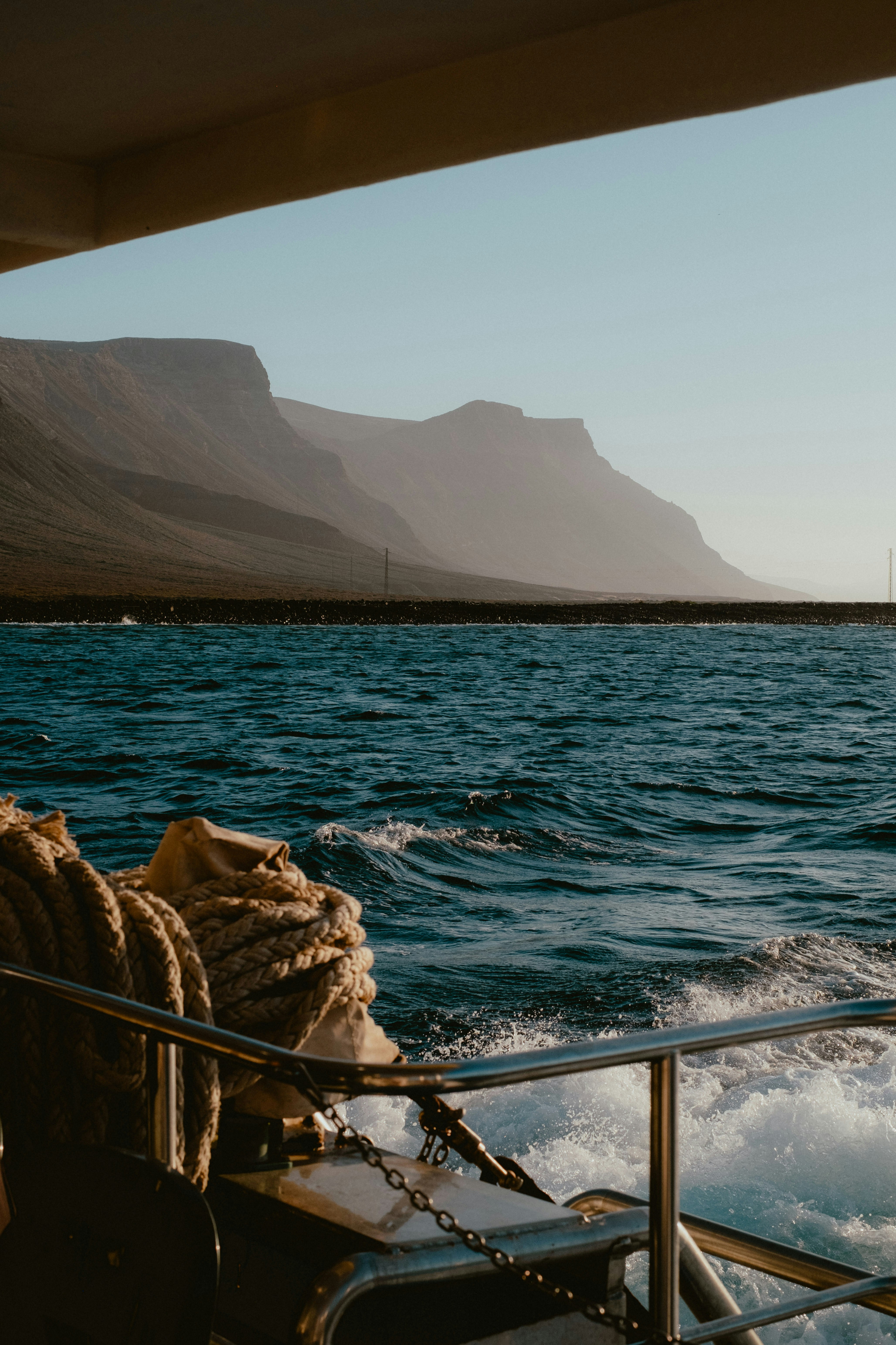 Monocoque sailing past mountains